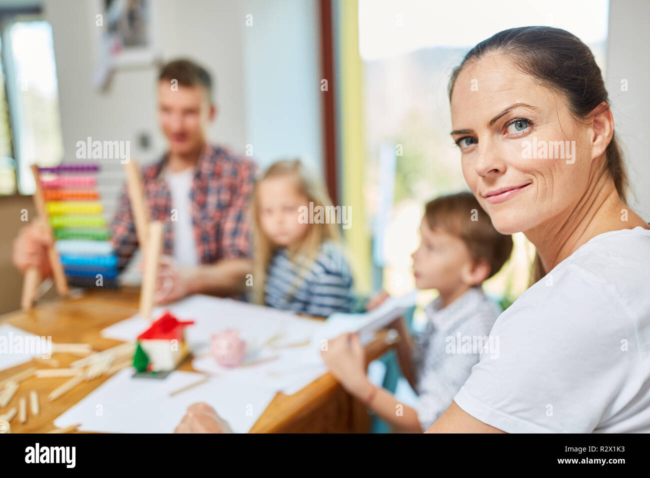 Mother dreams of home and plans house construction together with family Stock Photo