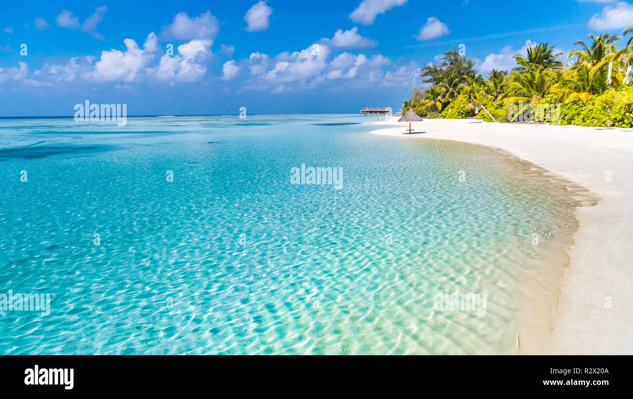 Summer travel destination. Design of summer vacation holiday concept. Perfect tranquil beach scene, soft sunlight and white sand and blue endless sea Stock Photo