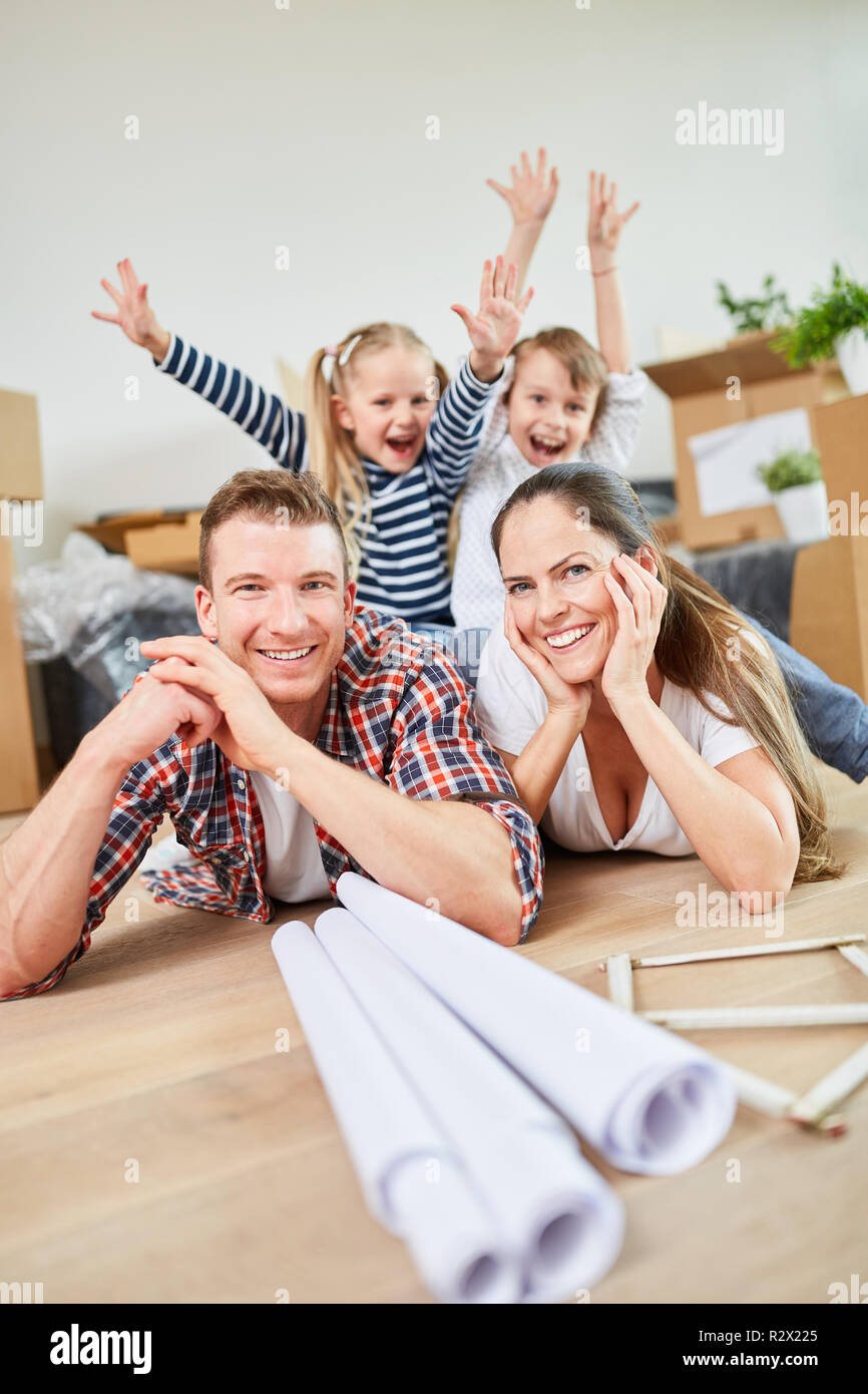 Parents and happy children celebrate the move to a new home as a home Stock Photo