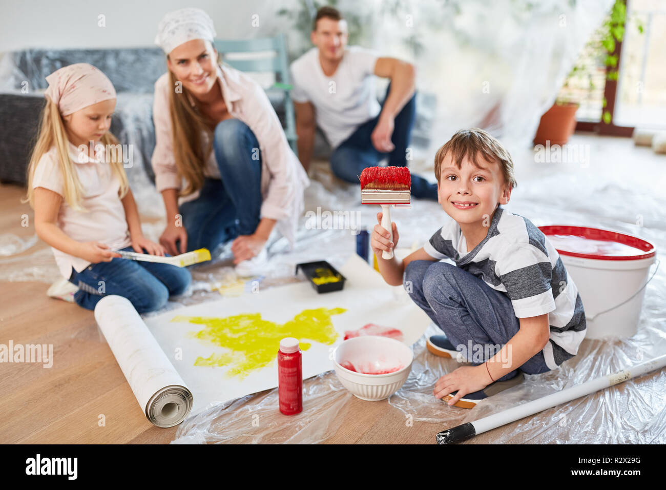 Children paint a wallpaper while renovating the new home as a home Stock Photo