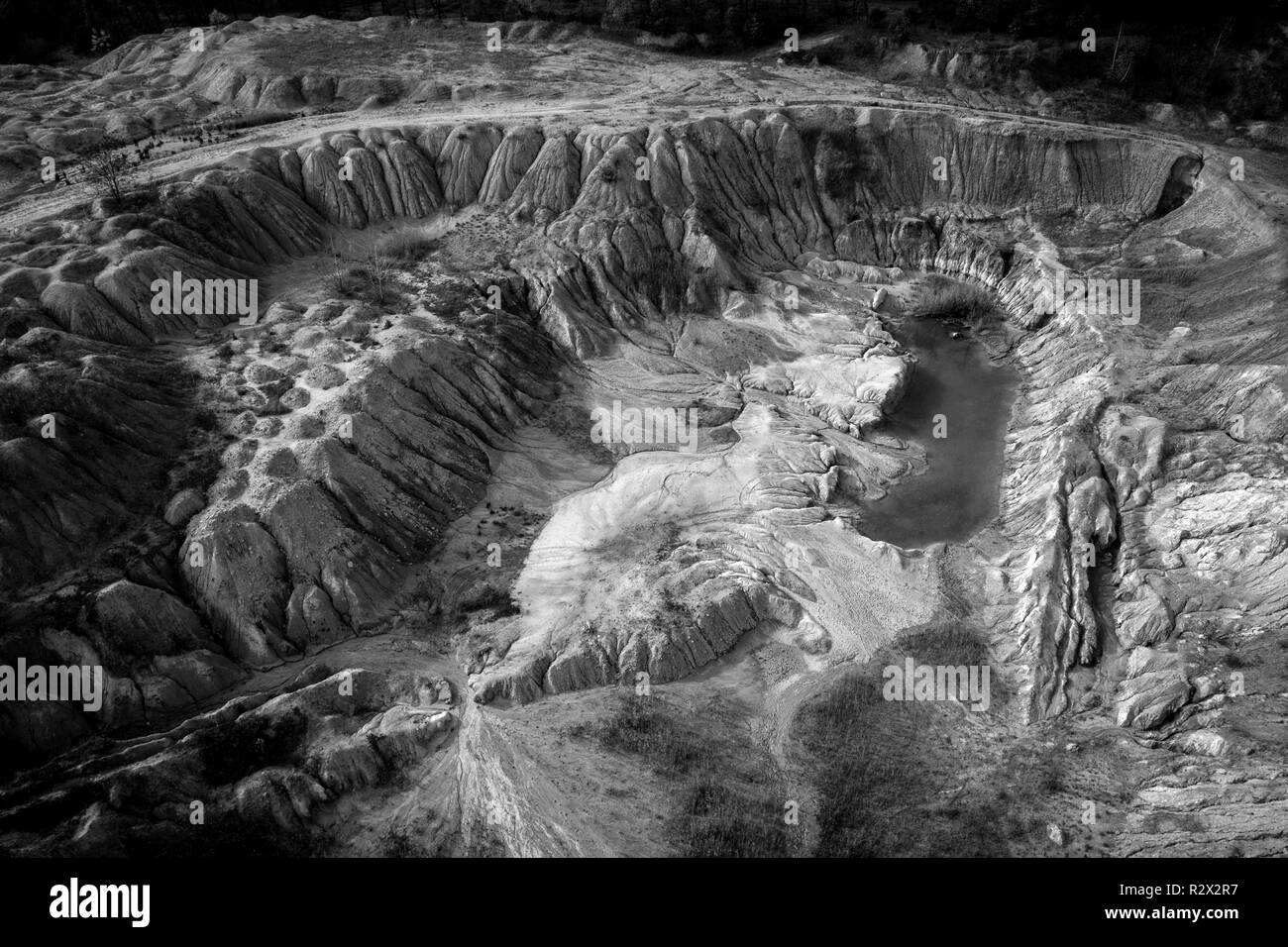 Black and white image of abandoned industrial exploitation, opencast mine. Aerial drone view Stock Photo