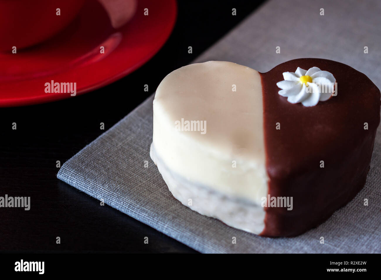 Chocolate covered biscuit heart shaped biscuit on a napkin Stock Photo