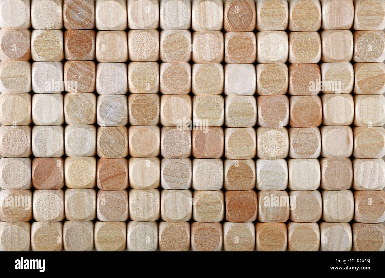Close up background pattern of natural wooden dice shaped toy building blocks, elevated high angle view, directly above Stock Photo