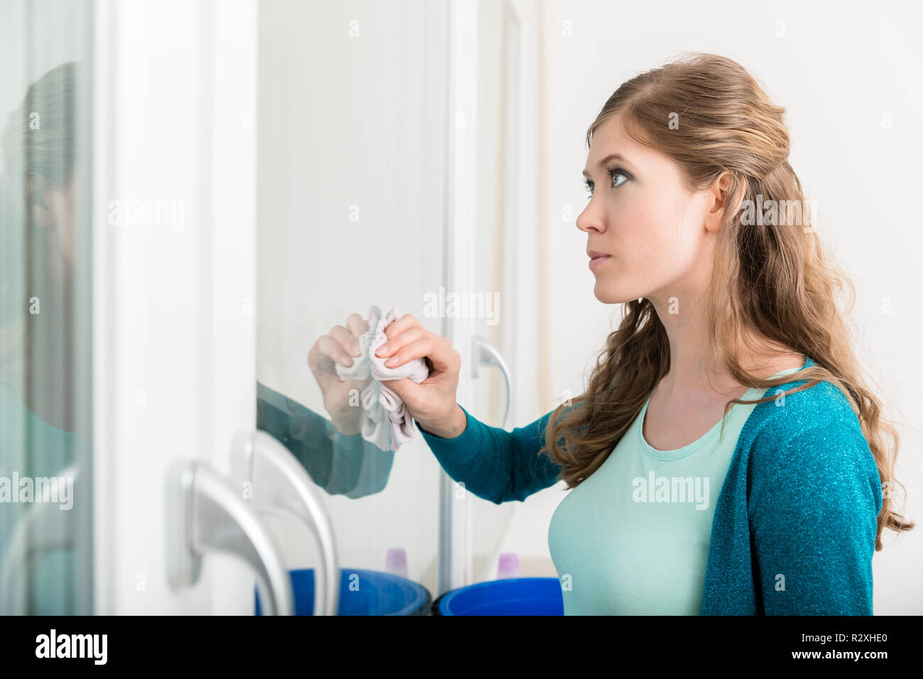 Woman cleaning the door glass with cloth Stock Photo Alamy