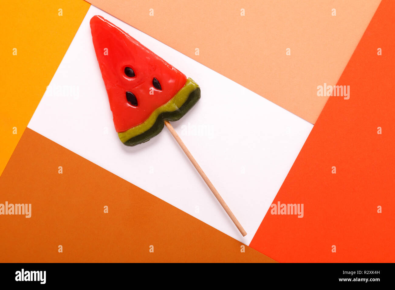 candy on a stick in a frame from a multi-colored cardboard Stock Photo