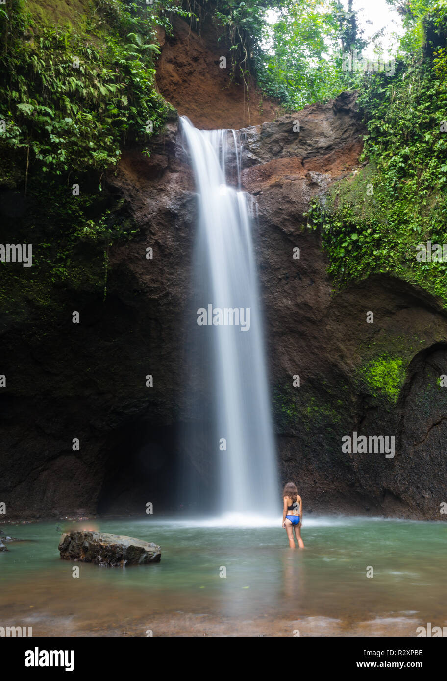 Girl In Front Of A Waterfall in Bali Stock Photo - Alamy
