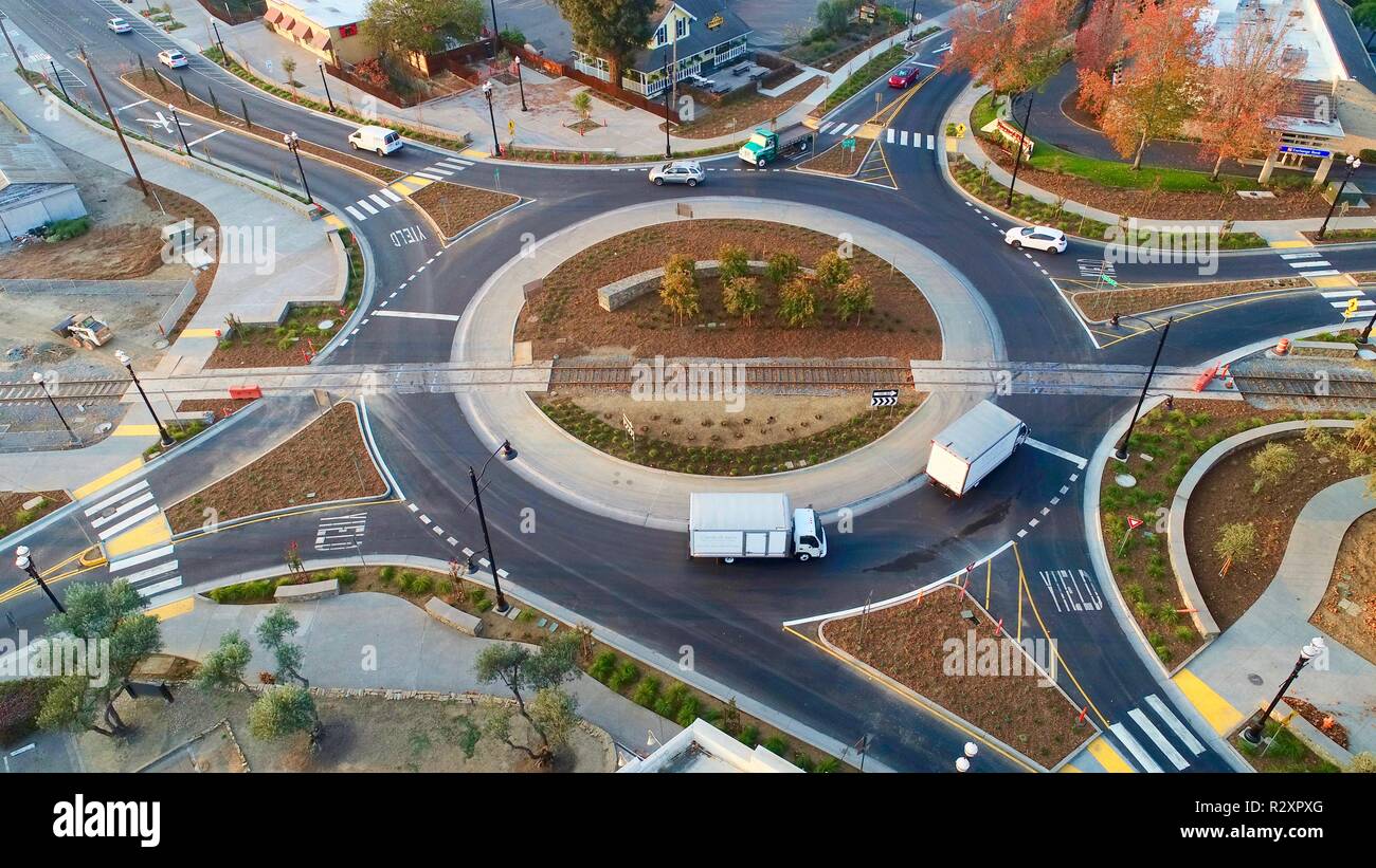 Aerial photo of cars, trucks & lorries, circling roundabout / circular road with railroad track, eliminating stop lights, Healdsburg, CA, USA Stock Photo