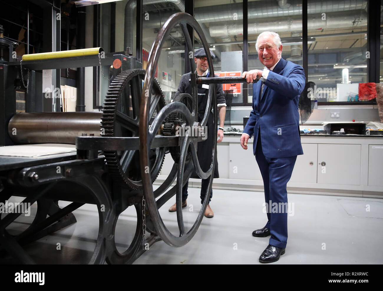 The Prince of Wales turns the wheel of the large Haddon etching press