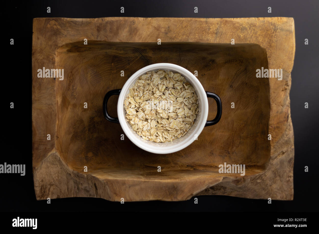 Breakfast on a wooden rectangular bowl with a black and white pot. Stock Photo