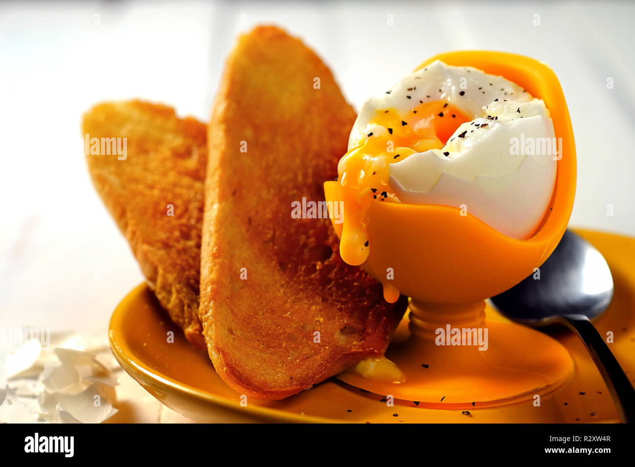 Nice soft boiled eggs for breakfast with bread and pepper on white background Stock Photo Alamy