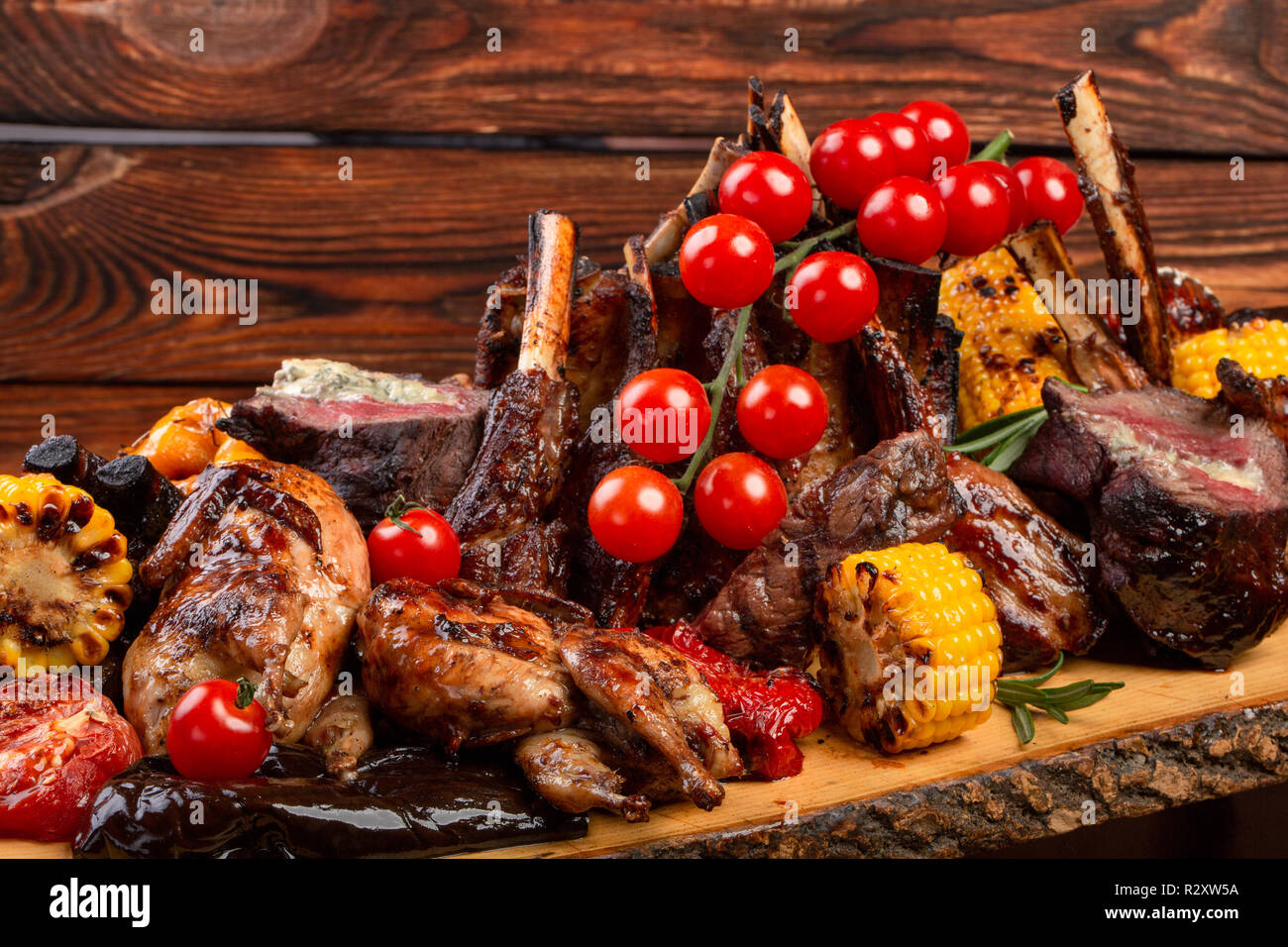 Mixed Grilled meat and vegetables on wooden background. restaurant feed Stock Photo