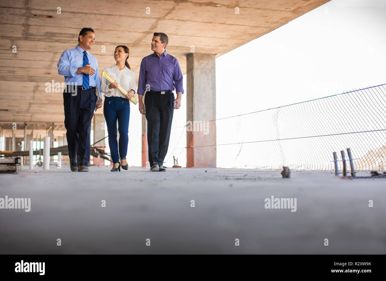 Three executives on building site Stock Photo Alamy