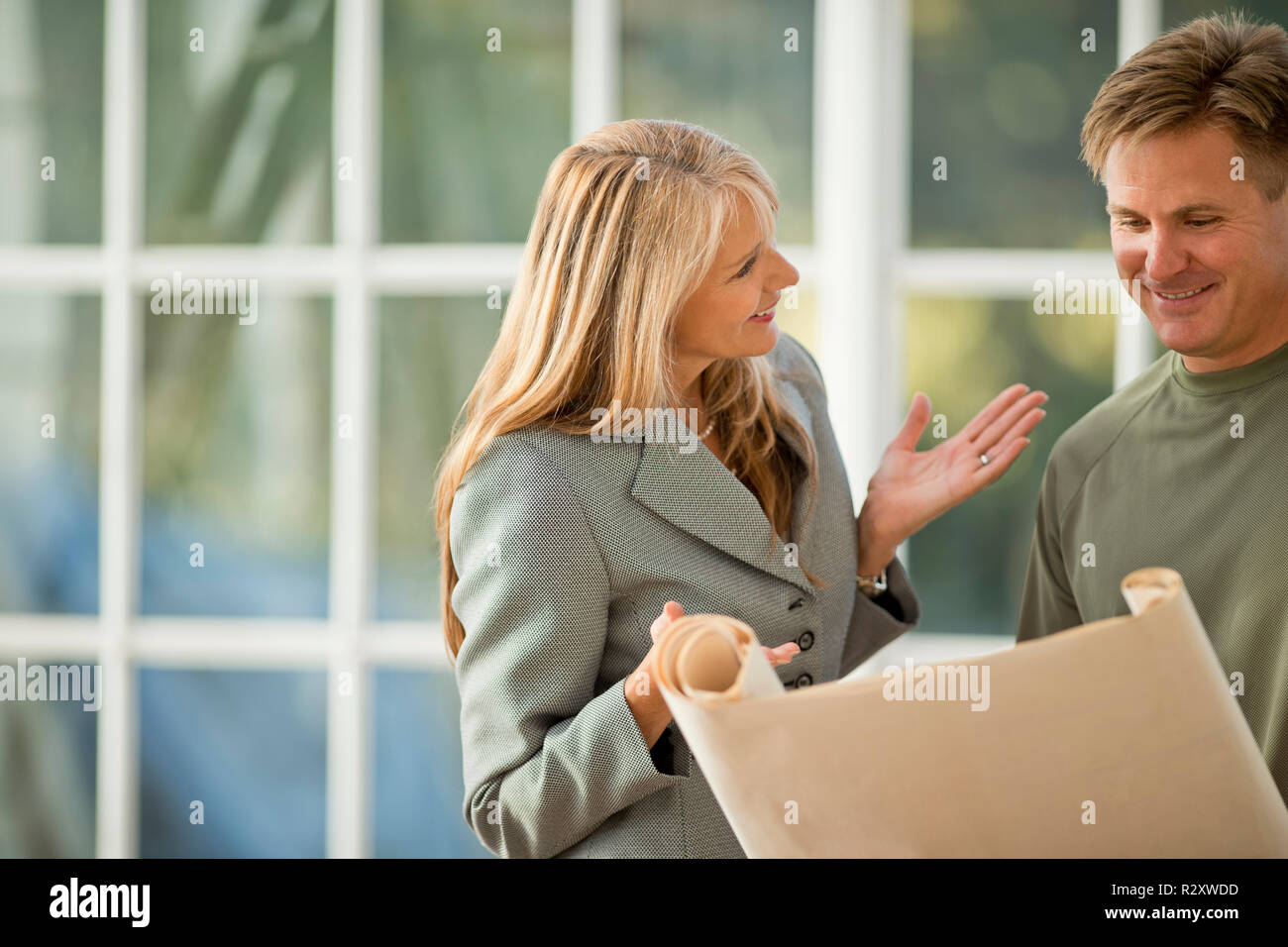 Businesswoman and contractor working together on a project. Stock Photo