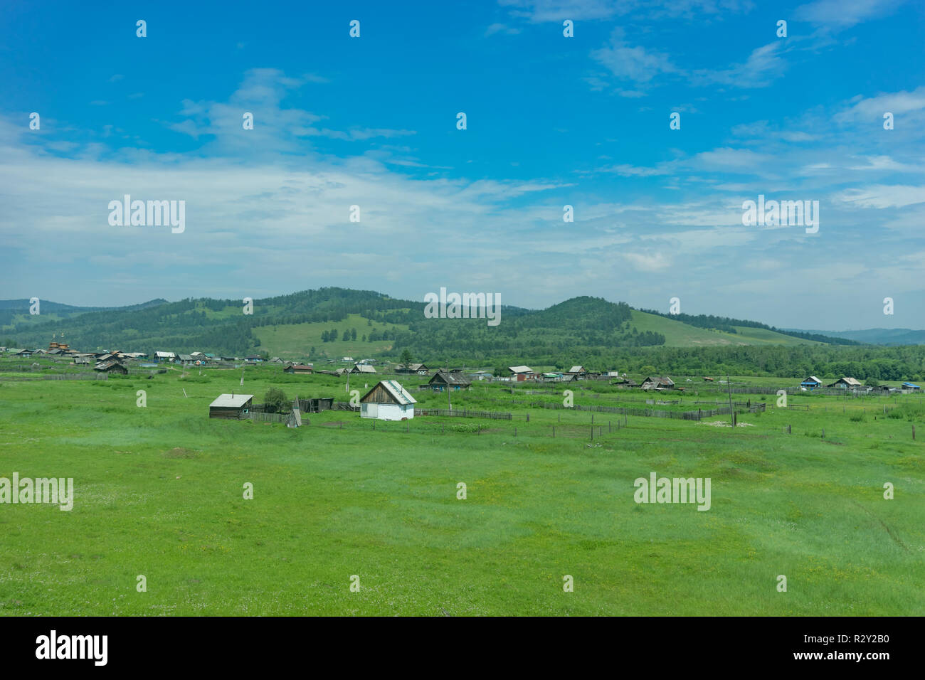 Rural landscape with houses, fields and mountains Stock Photo - Alamy