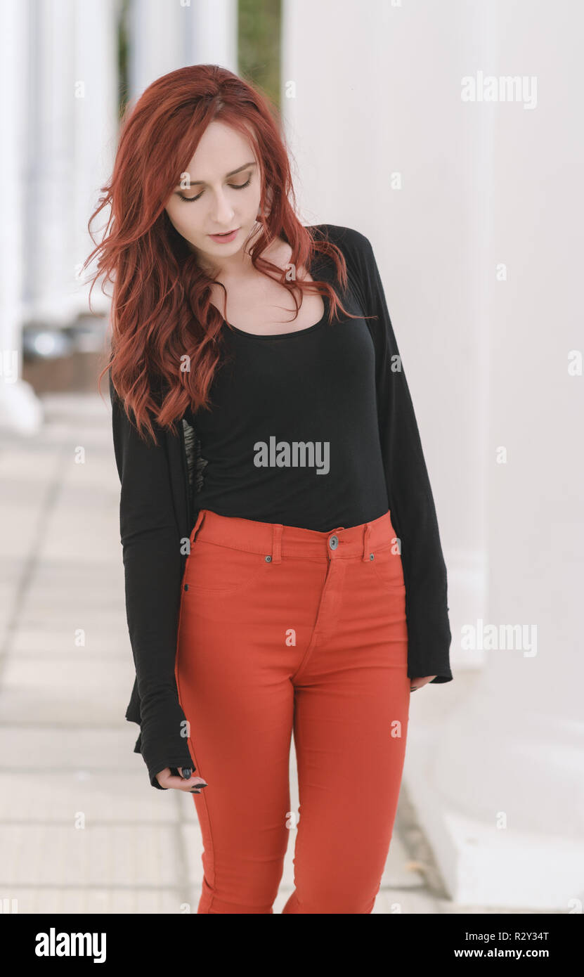 Portrait of attractive red haired young woman with blue eyes. Stock Photo