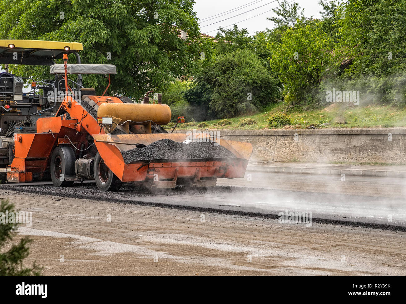 Asphalt Paver Machine Makes A New Road And Repairing Works. A Paver ...