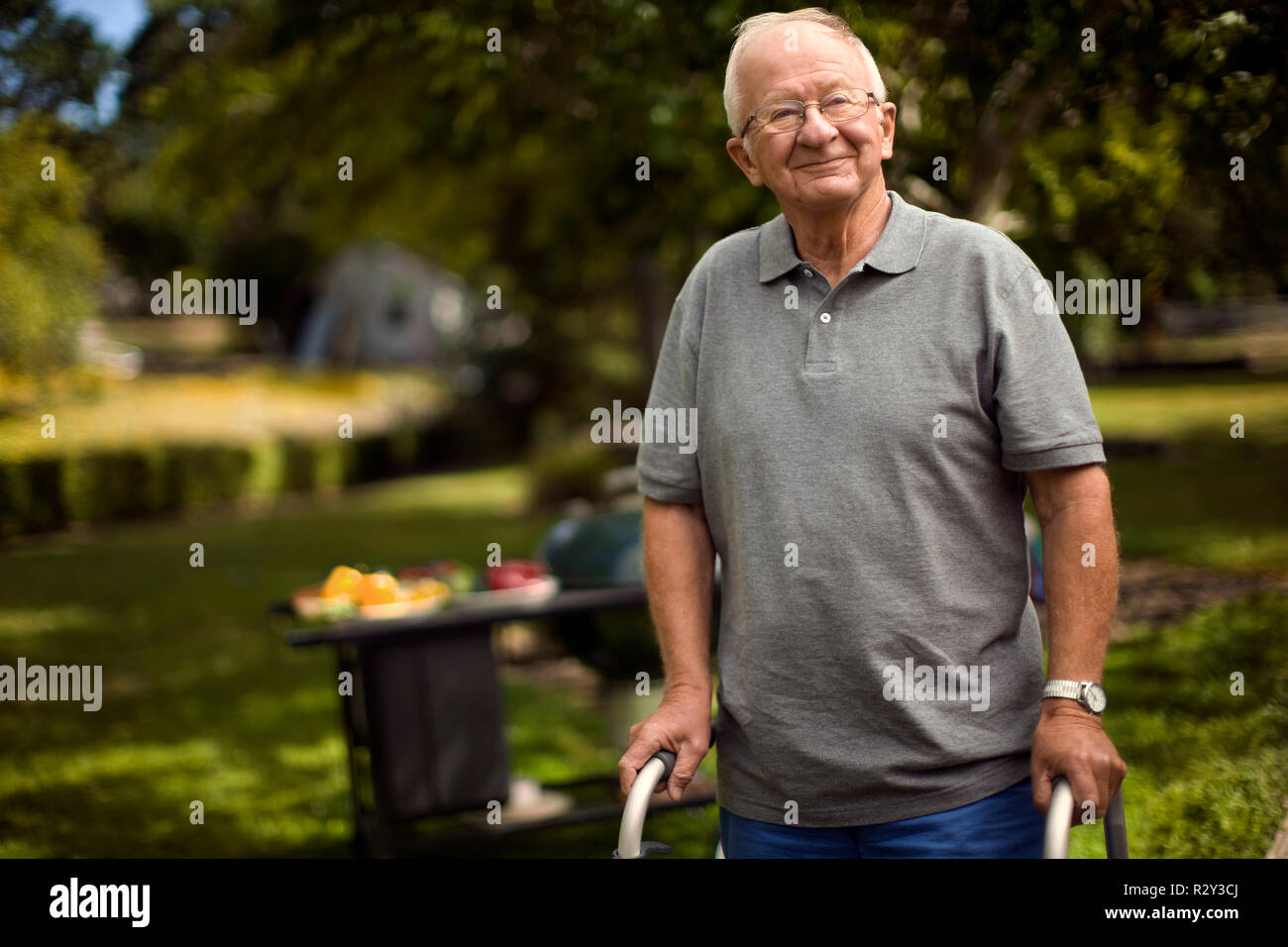 Portrait of a smiling senior man walking through a park. Stock Photo