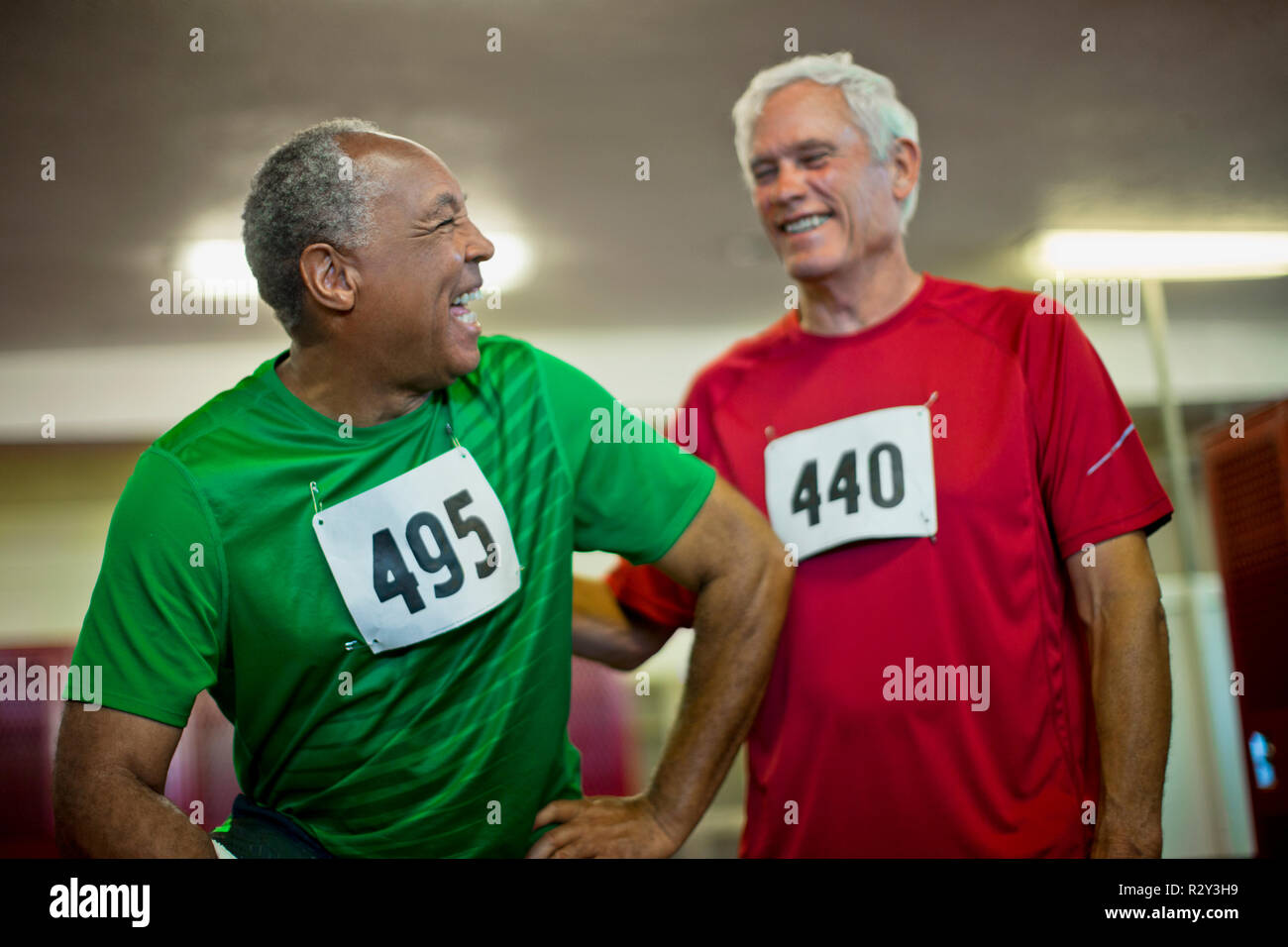 Senior men laughing and joking in a locker room. Stock Photo