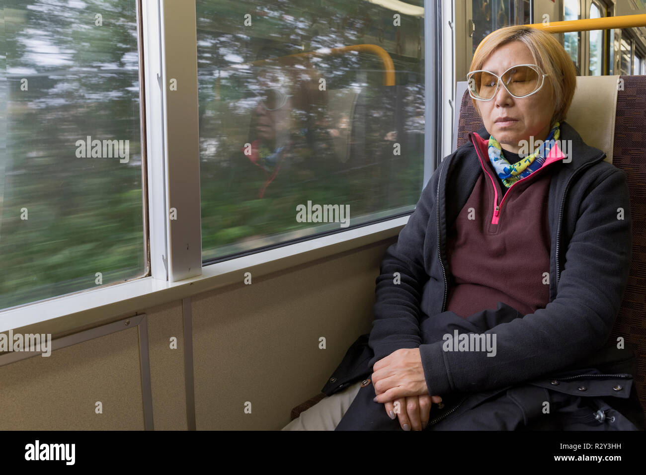 A woman sleeping on a train hi-res stock photography and images - Alamy