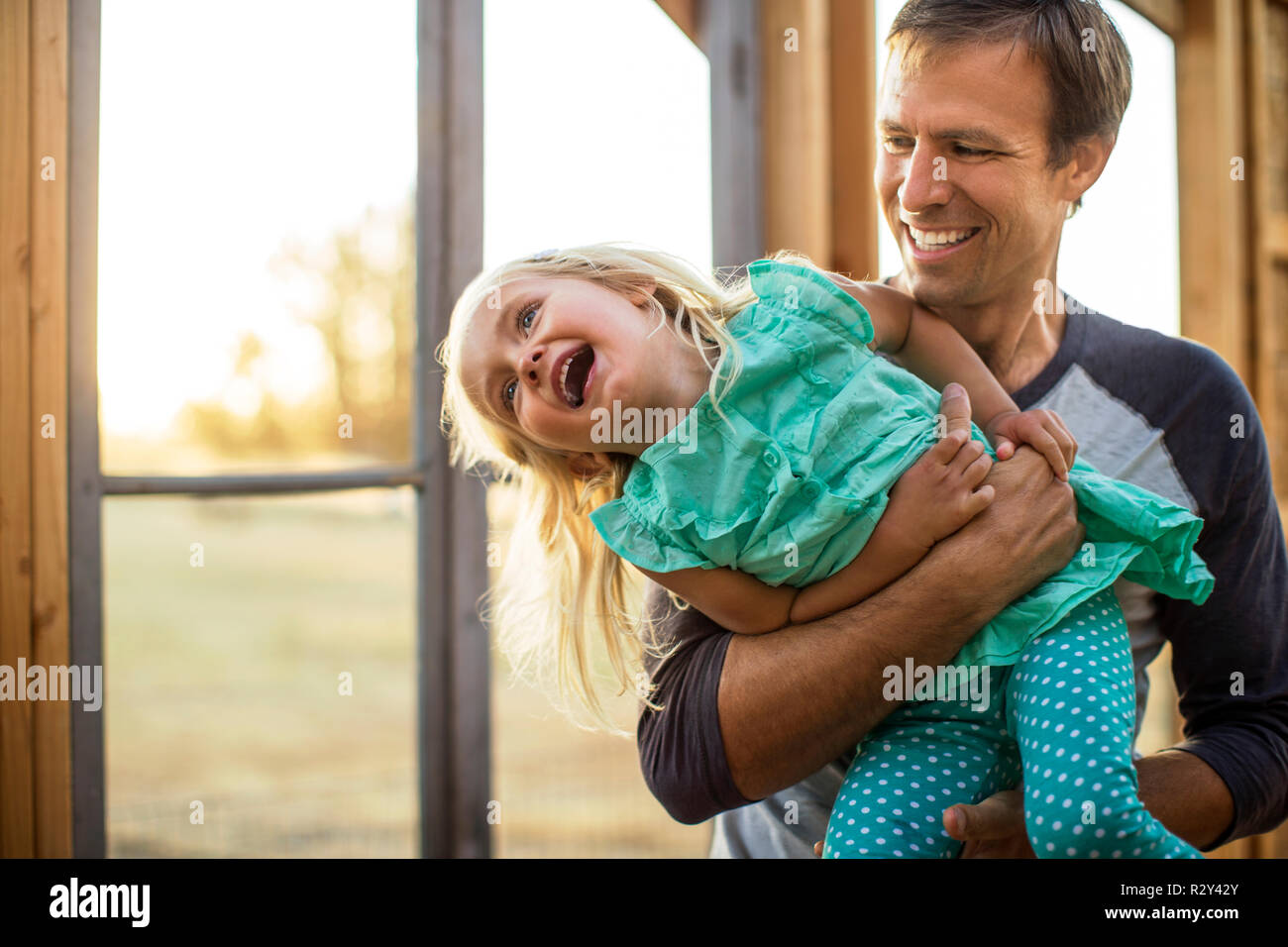 Playful young boy pulling his baby brother along in a wagon Stock Photo ...