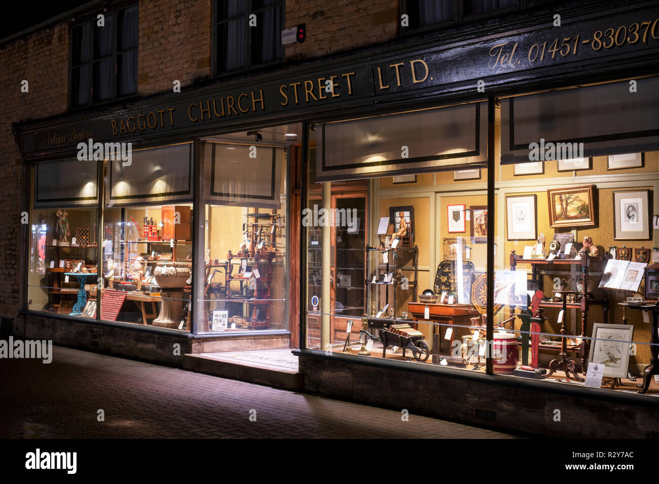 Baggott church street Ltd antiques shop window display at night. Stow
