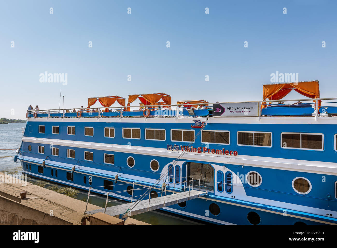 a blue cruise liner on the river Nile has its gangway fixed to the quay, Egypt, October 26, 2018 Stock Photo