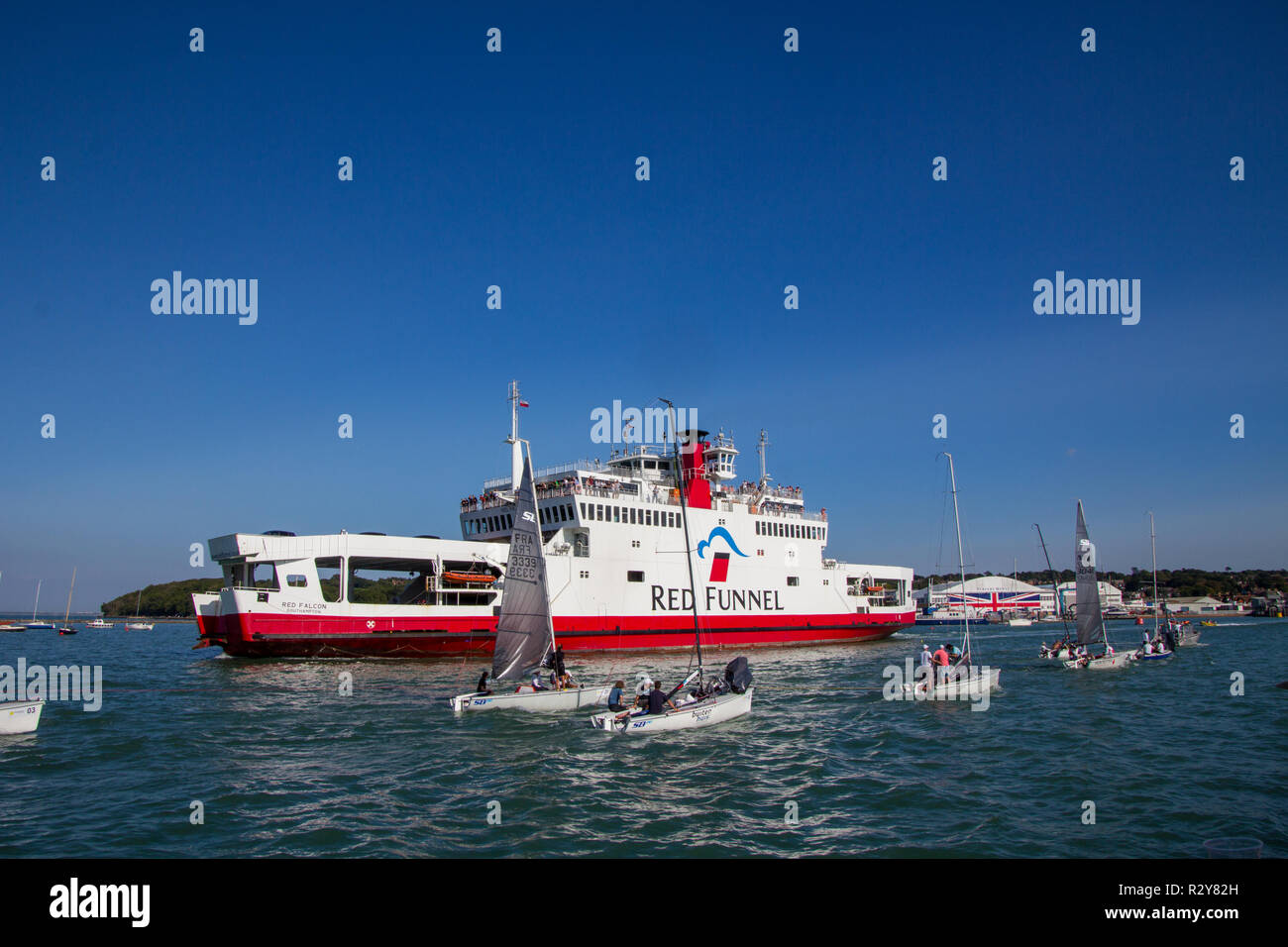 Red Funnel Ferry 'Red Falcon' Passing a Line of Dinghies, Cowes, Isle of Wight, UK Stock Photo