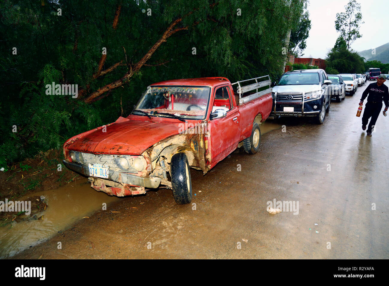 Old red pickup truck in bad condition parked next to road near Tarija, Bolivia Stock Photo
