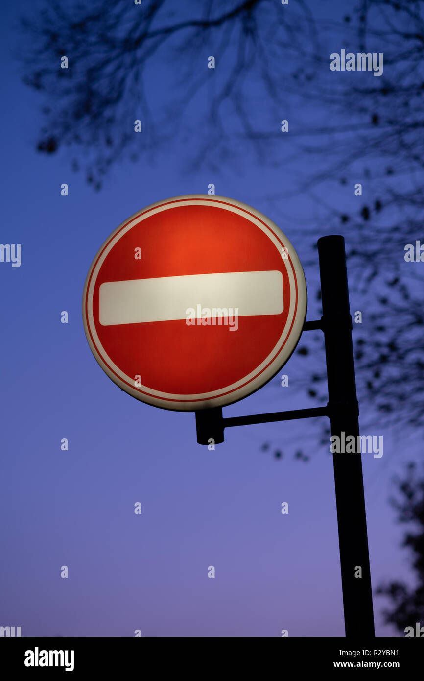 Illuminated no entry sign at dusk in winter UK Stock Photo - Alamy