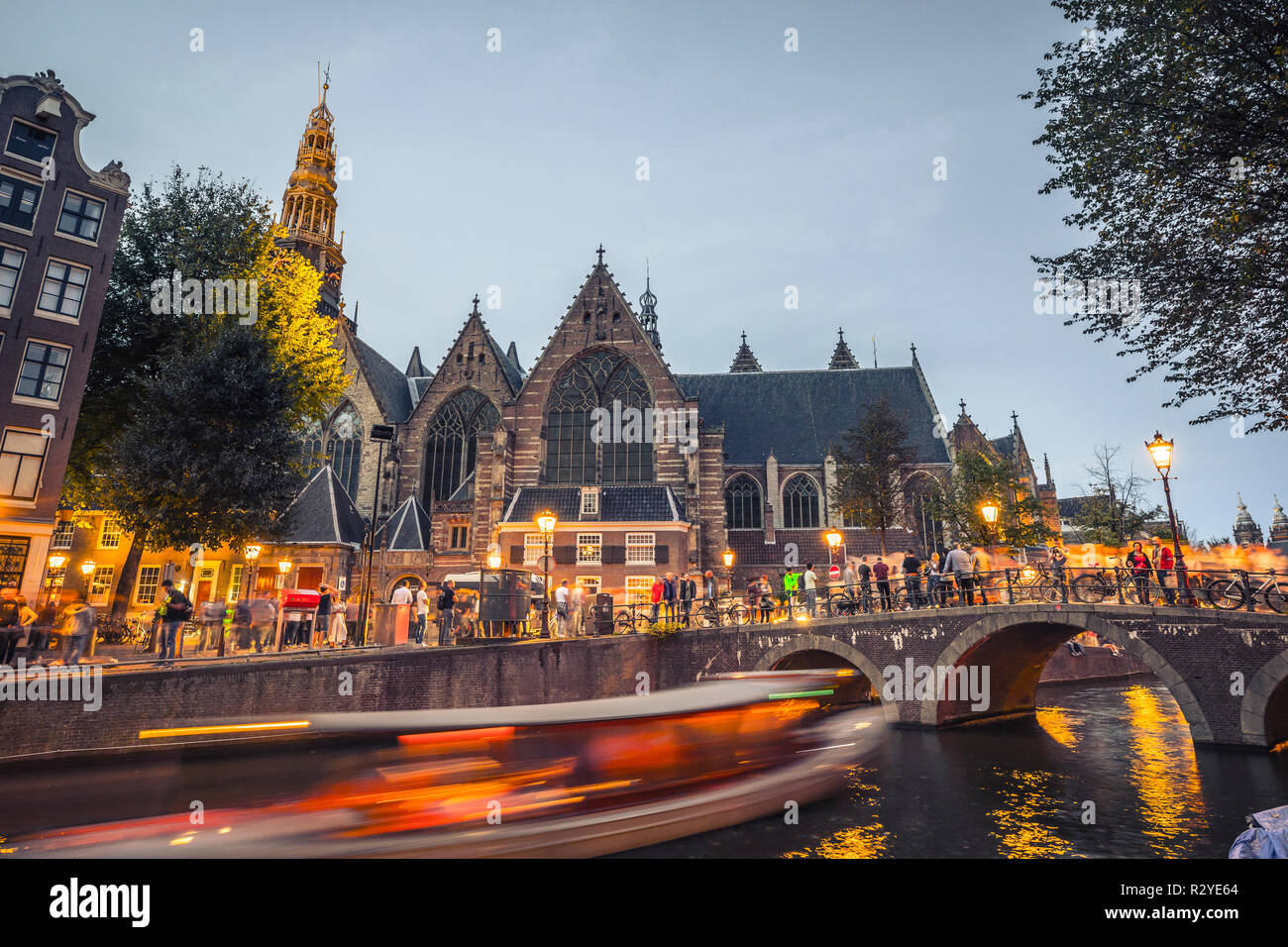 Amsterdam “Oude Kerk” church and old bridge in evening Stock Photo