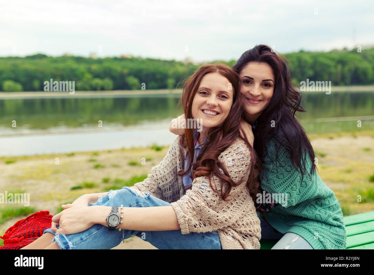 Close up lifestyle portrait of two pretty sisters smiling hugs. Family values concept. Stock Photo