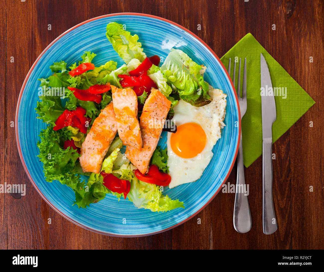 Light dietary breakfast of trout fillet, scrambled eggs and vegetables ...