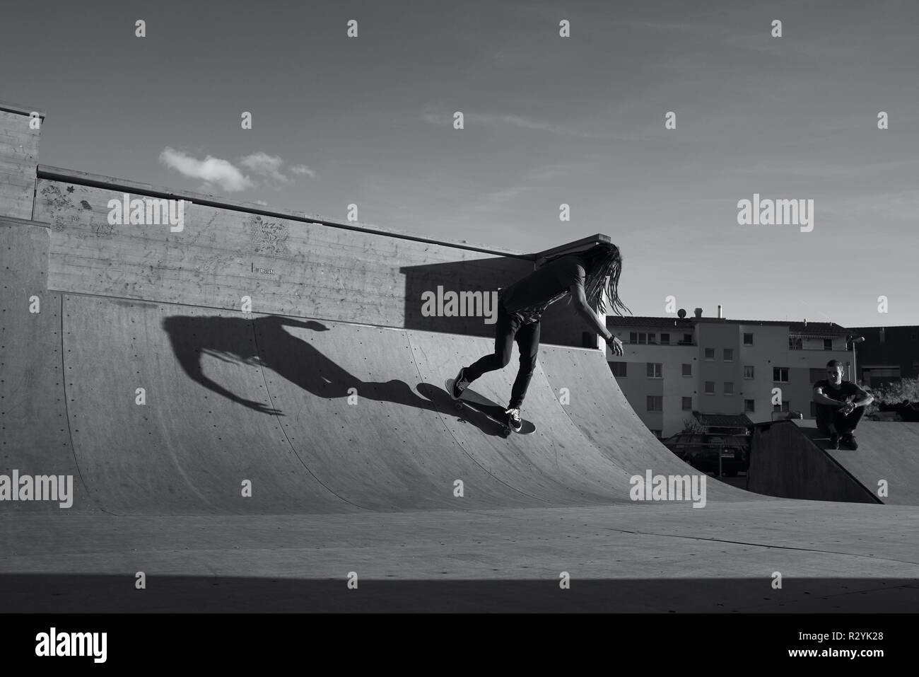 Black and White image of a Skateboarder in a Halfpipe Stock Photo