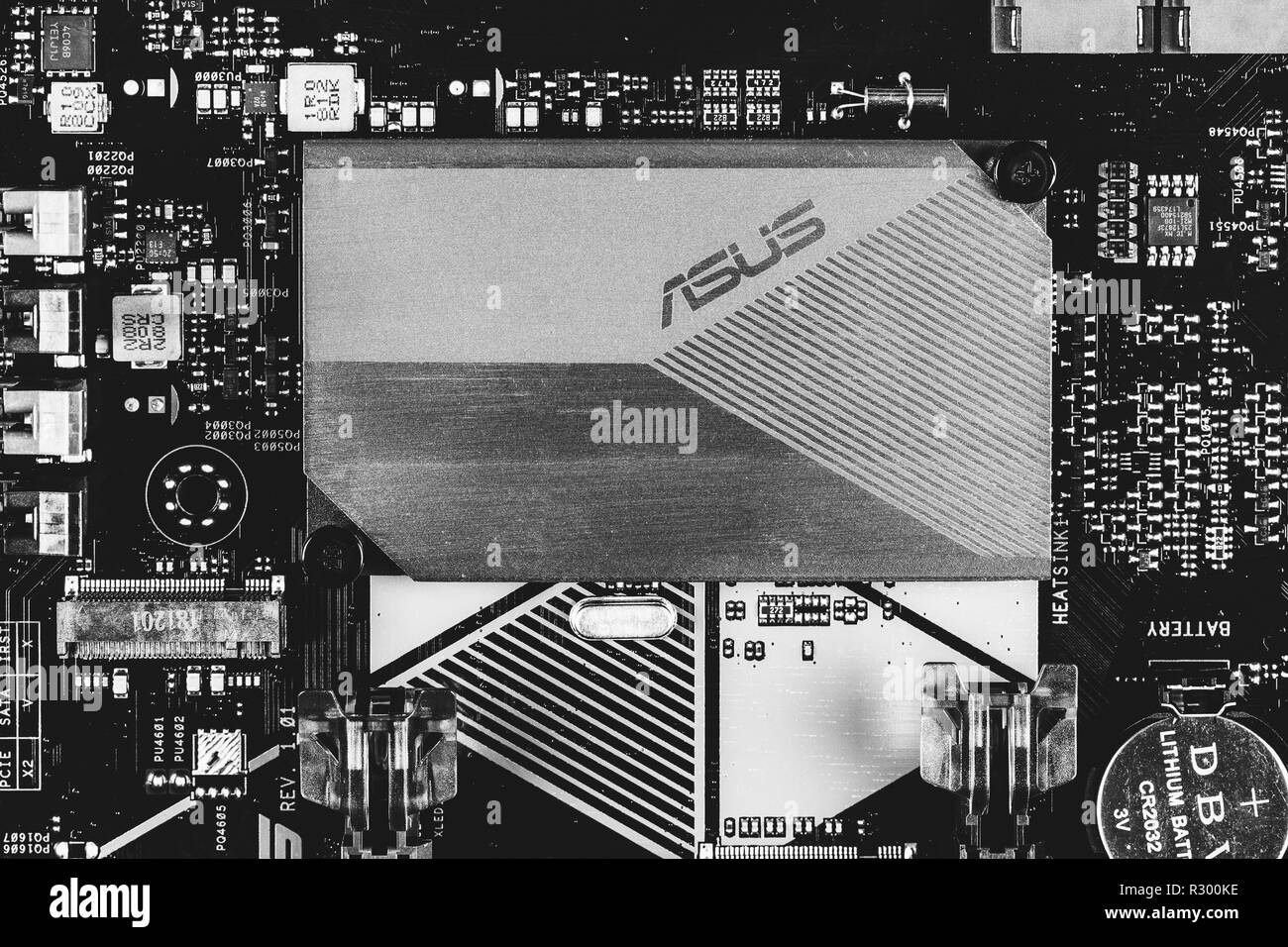 Maykop, Russia - November 9, 2018: part of ASUS motherboard with aluminum radiator chipset top view close-up, black and white photo Stock Photo