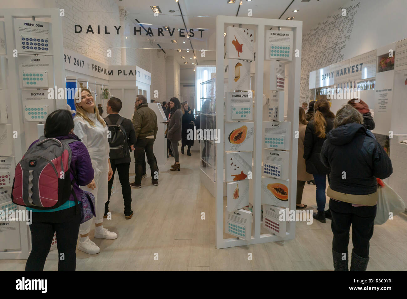 Visitors enjoy smoothies, soups and harvest bowls at the Daily Harvest subscription meal start-up 'Refueling Station' pop-up store in New York on opening day, Wednesday, November 14, 2018. The company sells pre-portioned cups, which you choose on a weekly or monthly commitment, that arrive frozen which you can heat, soak, or blend.  (© Richard B. Levine) Stock Photo