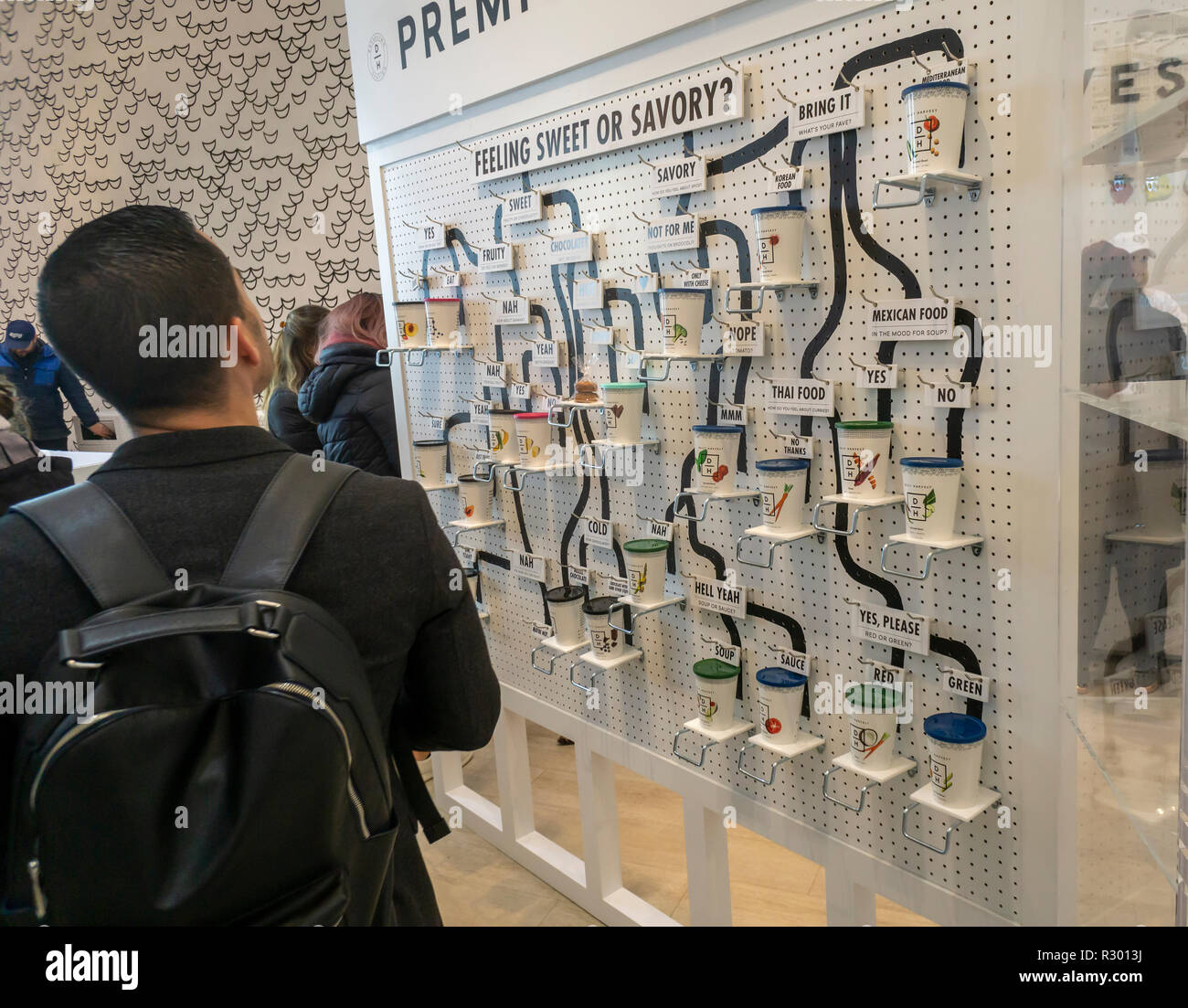 Visitors enjoy smoothies, soups and harvest bowls at the Daily Harvest subscription meal start-up 'Refueling Station' pop-up store in New York on opening day, Wednesday, November 14, 2018. The company sells pre-portioned cups, which you choose on a weekly or monthly commitment, that arrive frozen which you can heat, soak, or blend.  (© Richard B. Levine) Stock Photo