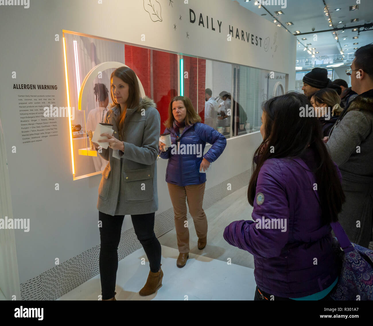 Visitors enjoy smoothies, soups and harvest bowls at the Daily Harvest subscription meal start-up 'Refueling Station' pop-up store in New York on opening day, Wednesday, November 14, 2018. The company sells pre-portioned cups, which you choose on a weekly or monthly commitment, that arrive frozen which you can heat, soak, or blend.  (© Richard B. Levine) Stock Photo