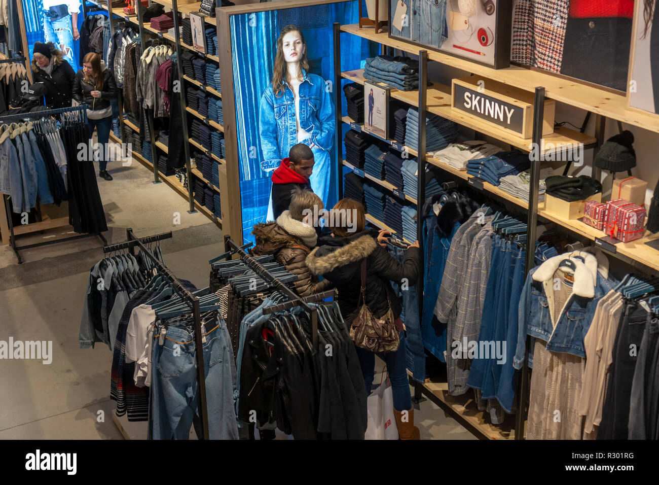Shoppers search for denim in the Levi Strauss and Co.'s new flagship store  in Times Square in New York on its grand opening day, Friday, November 16,  2018. The king of blue