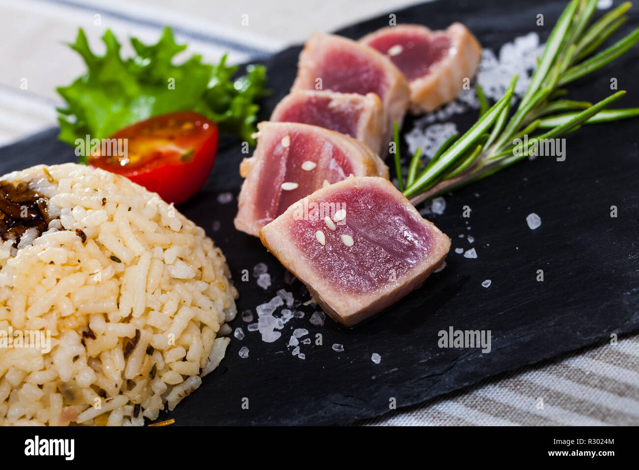 Delicious treat for seafood lovers tuna tataki with garnish of rice with ponzu sauce and fresh
