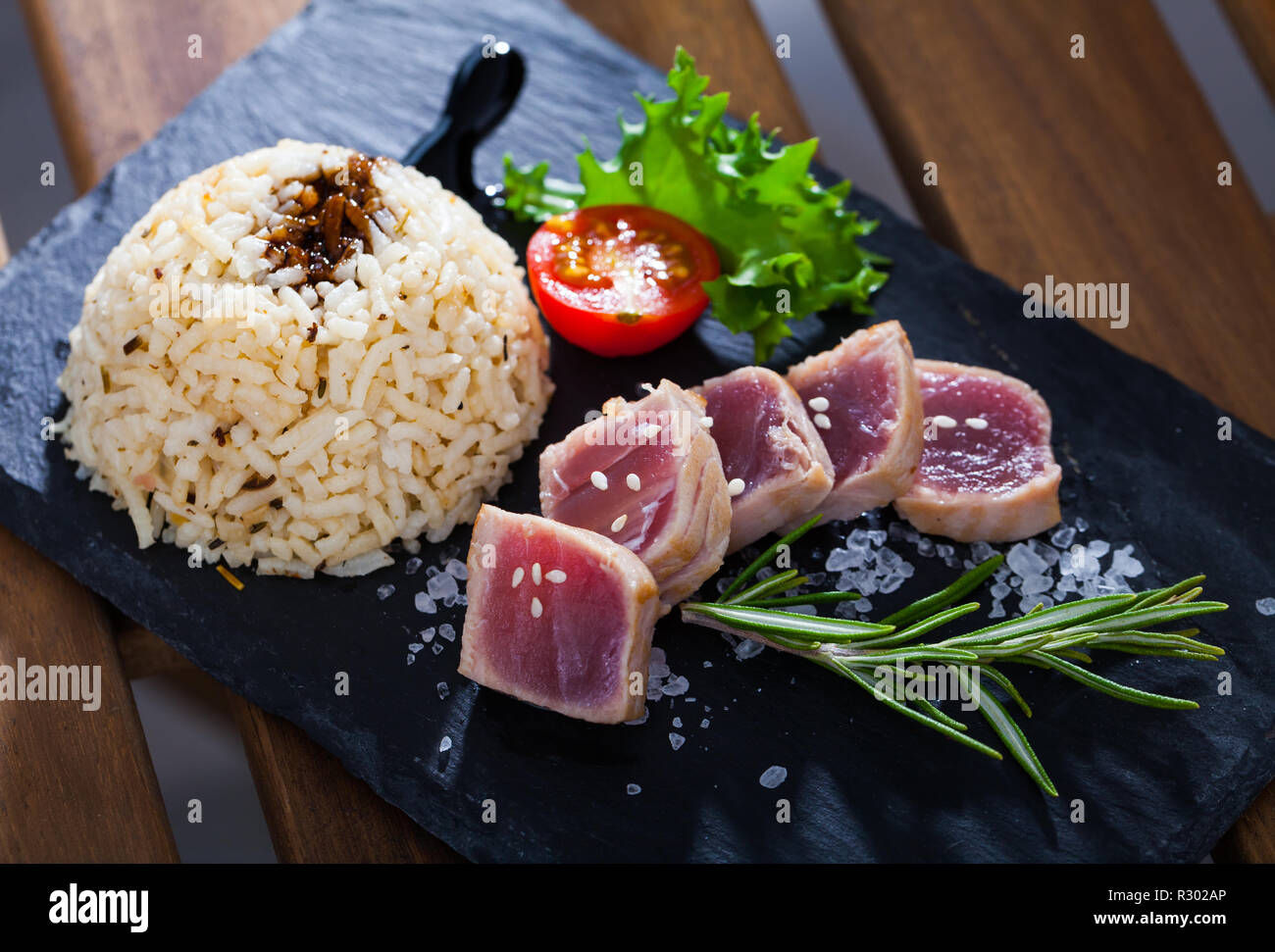 Delicious treat for seafood lovers tuna tataki with garnish of rice with ponzu sauce and fresh