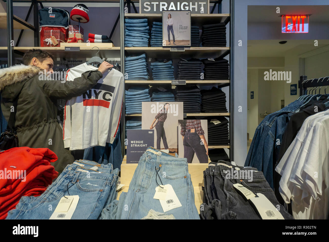 Shoppers search for denim in the Levi Strauss and Co.'s new flagship store  in Times Square in New York on its grand opening day, Friday, November 16,  2018. The king of blue