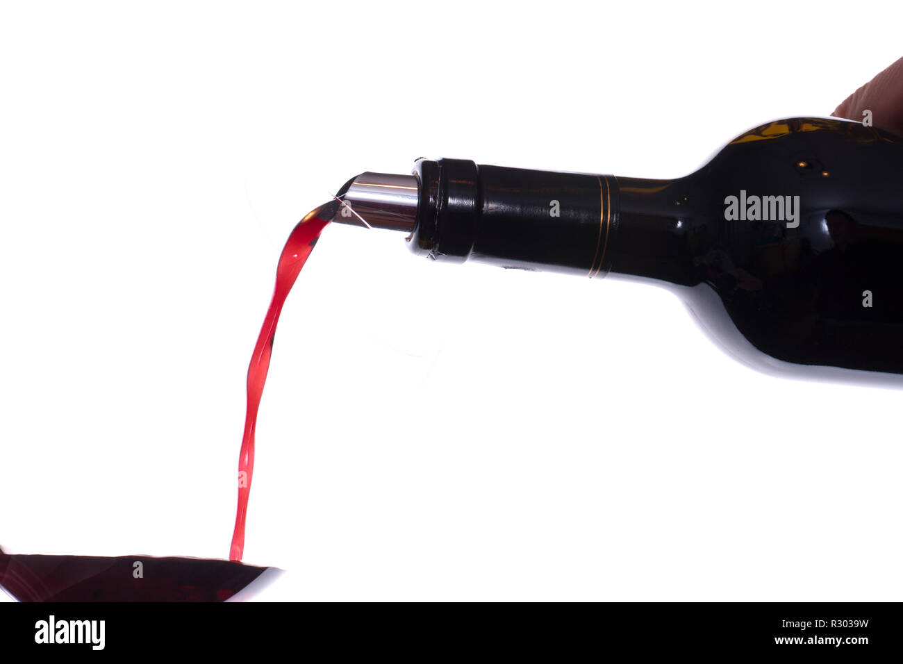 pour red wine into a glass Stock Photo