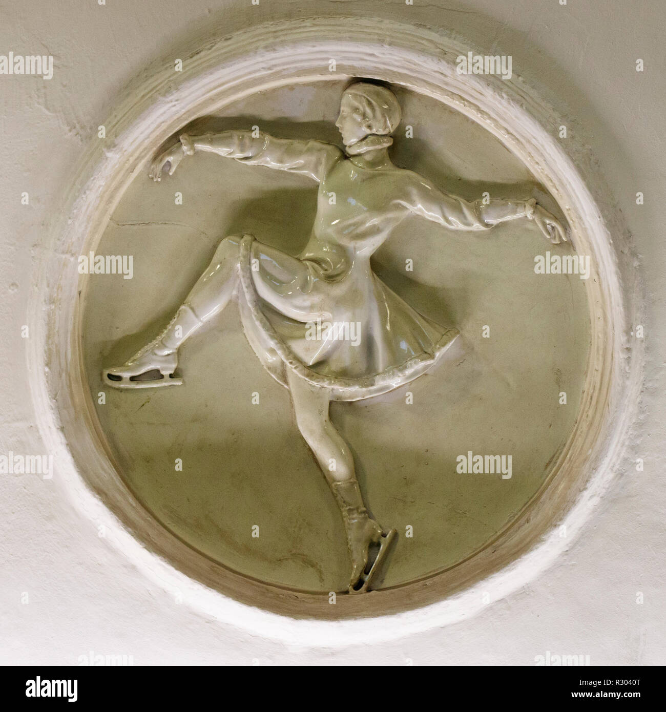 Plaster roundel depicting an ice skater in the Moscow Metro station of Dinamo, Russia. Said to bring luck to similar sports people that visit them. Stock Photo