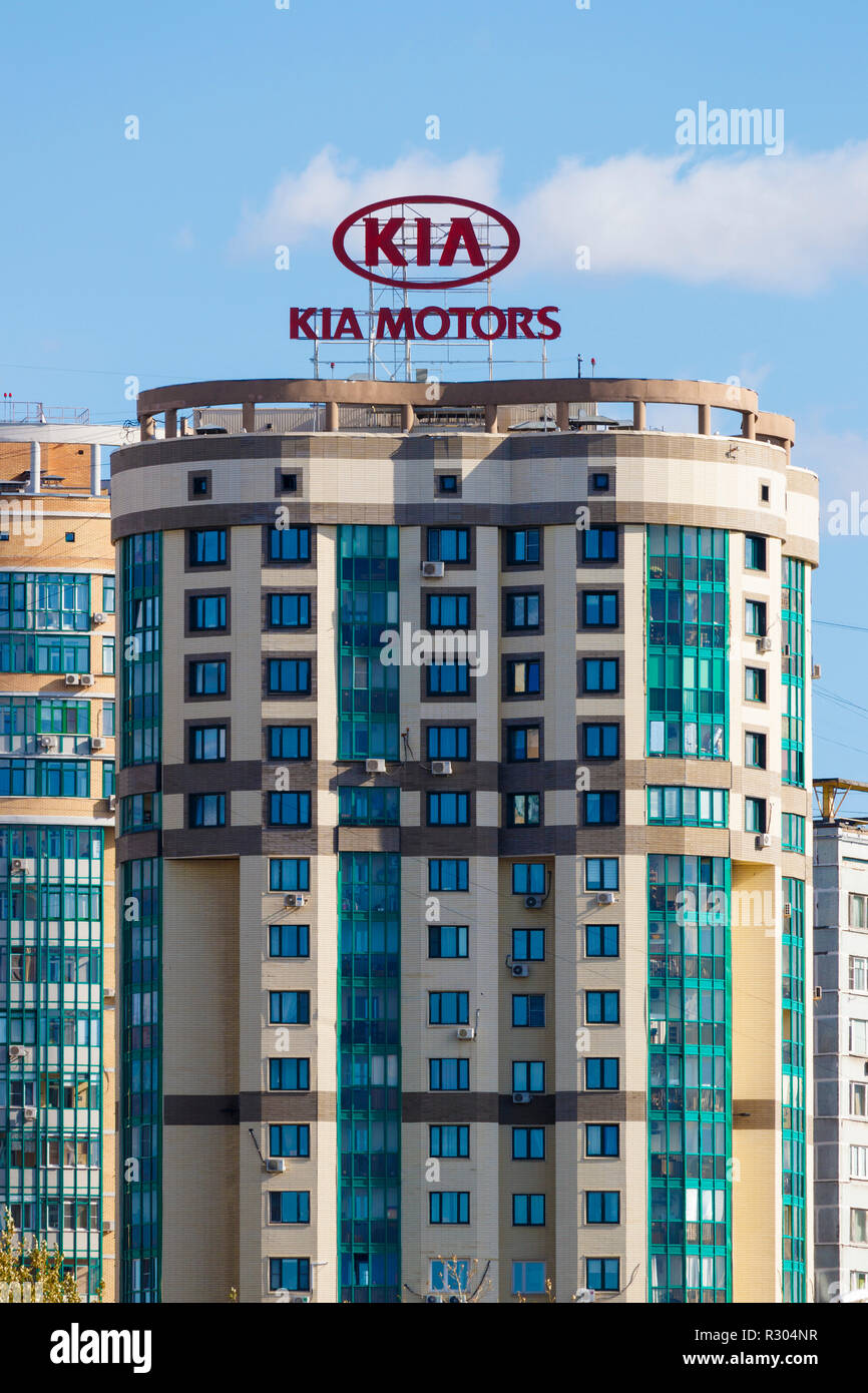 Kia Motors advertising sign, illumunated at night, on top of an apartment block in Moscow, Russia. Adjacent to the Moscow canal. Stock Photo