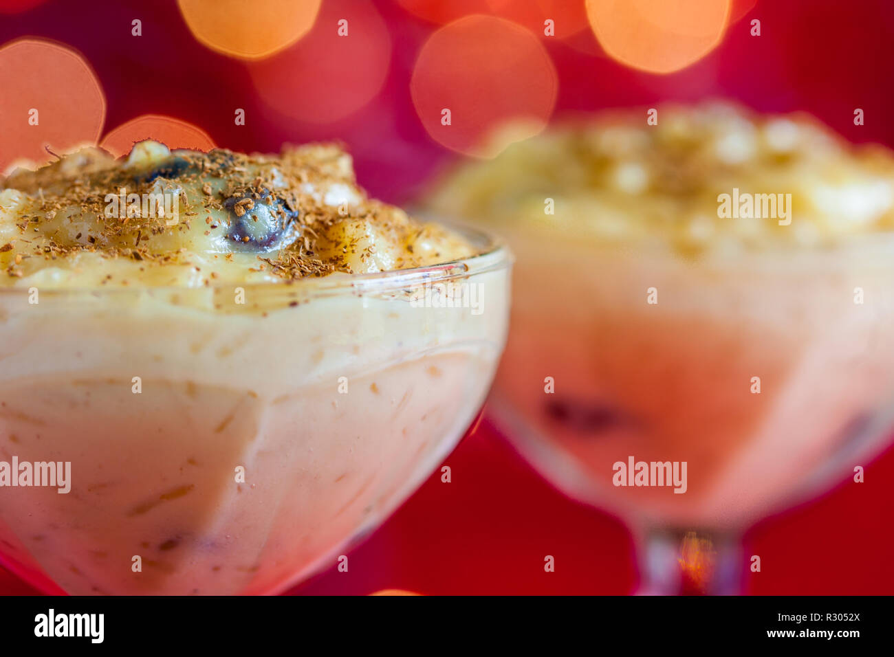 Traditional Colombian dessert made of rice and milk called arroz de leche on a christmas red background Stock Photo