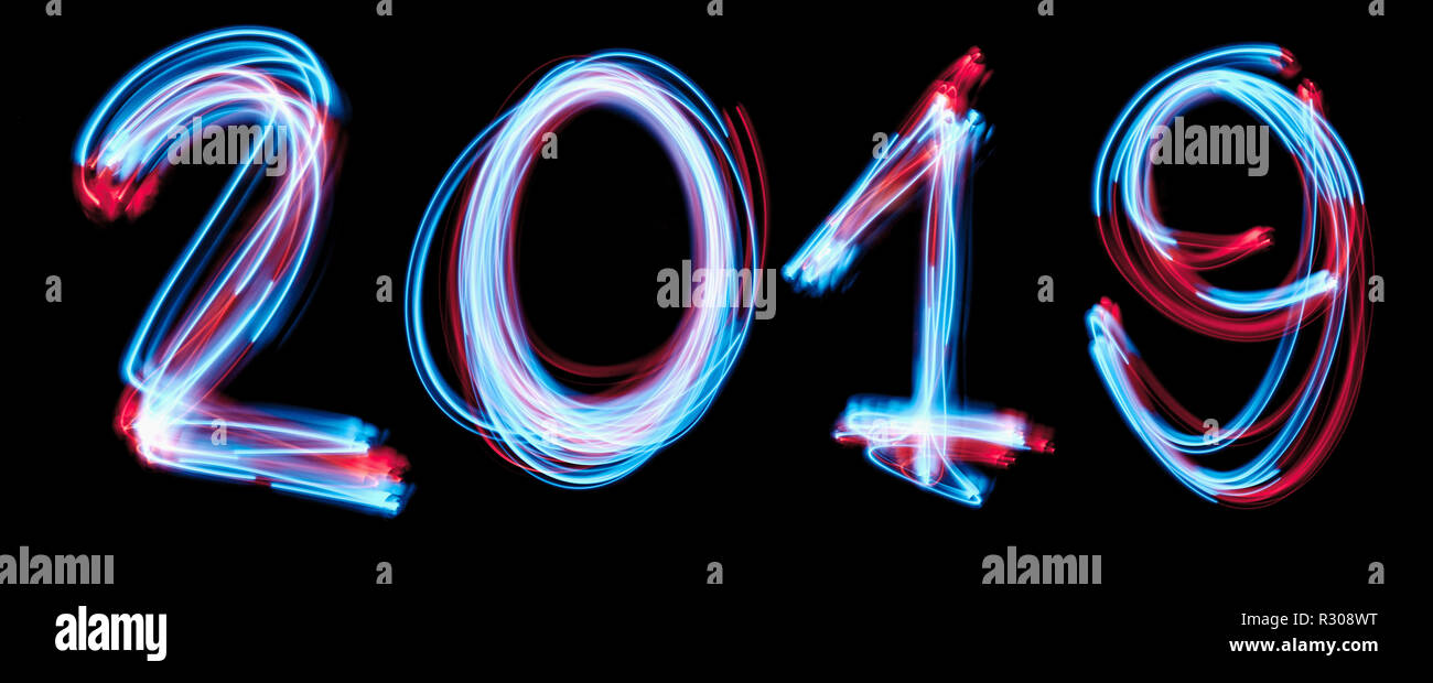 2019 happy new year number with neon lights backgrorund. blue light image, long exposure with colored fairy lights, against a black Stock Photo