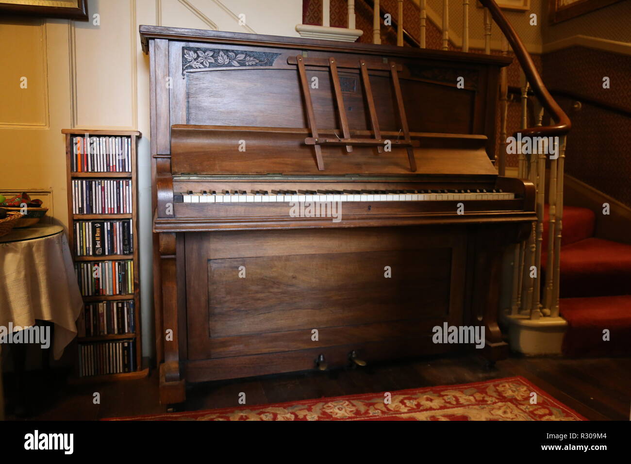 Old upright piano in hallway Stock Photo