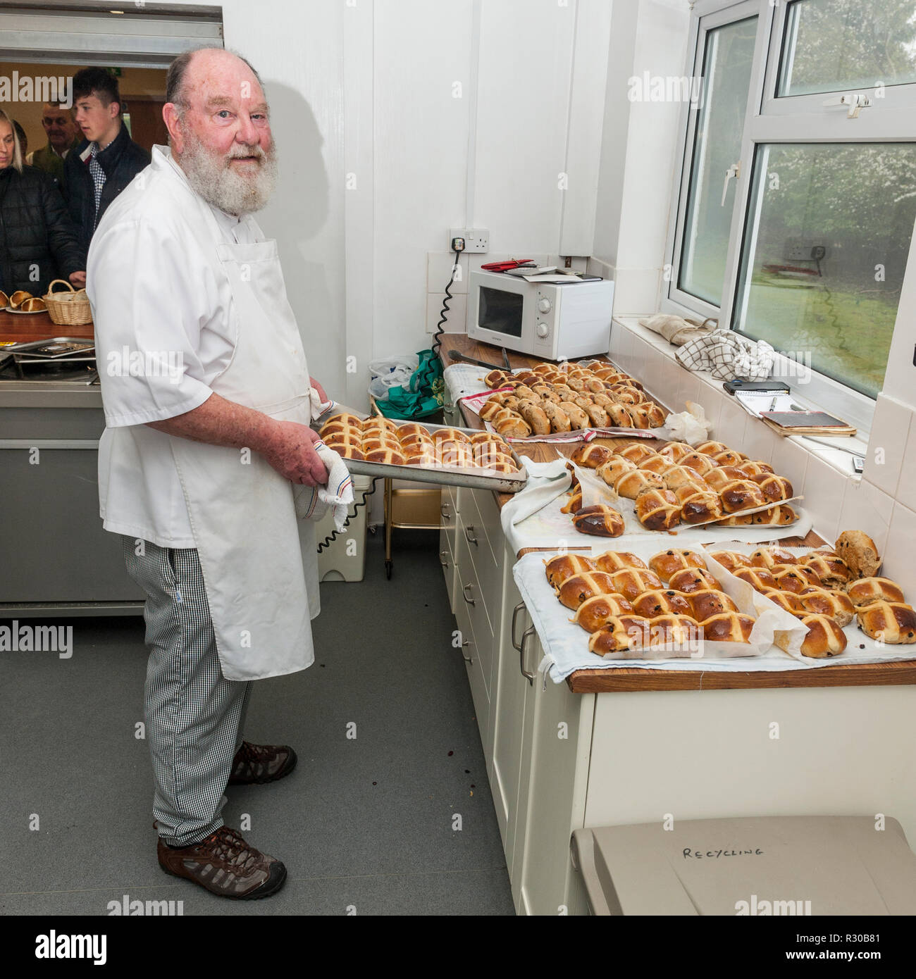 A retired chef cooking hot cross buns in the Uk Stock Photo