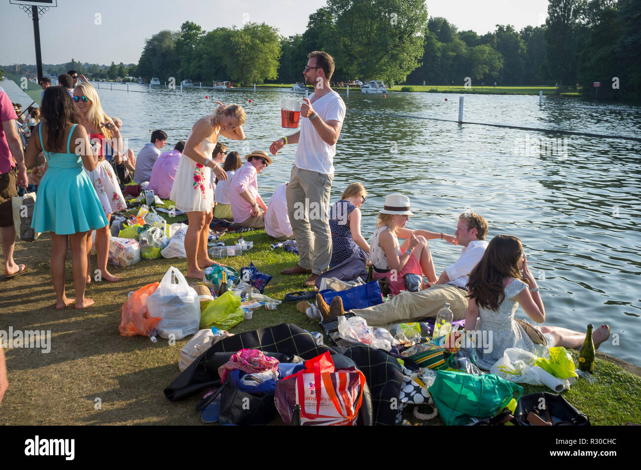 Specators picnic by the towpath at Henley Regatta, Henleyonthames