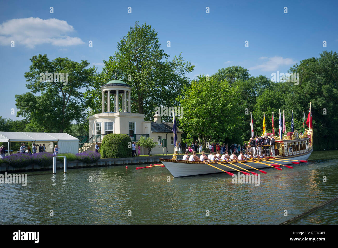 The Queen's row barge Gloriana passes Temple Island at Henley Royal Regatta, Henley-on-Thames, Oxfordshire Stock Photo